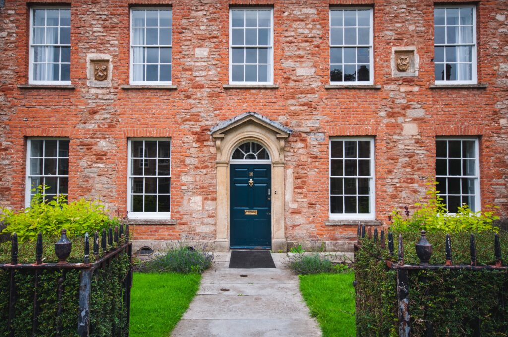 Facade of European country manor with blue front door