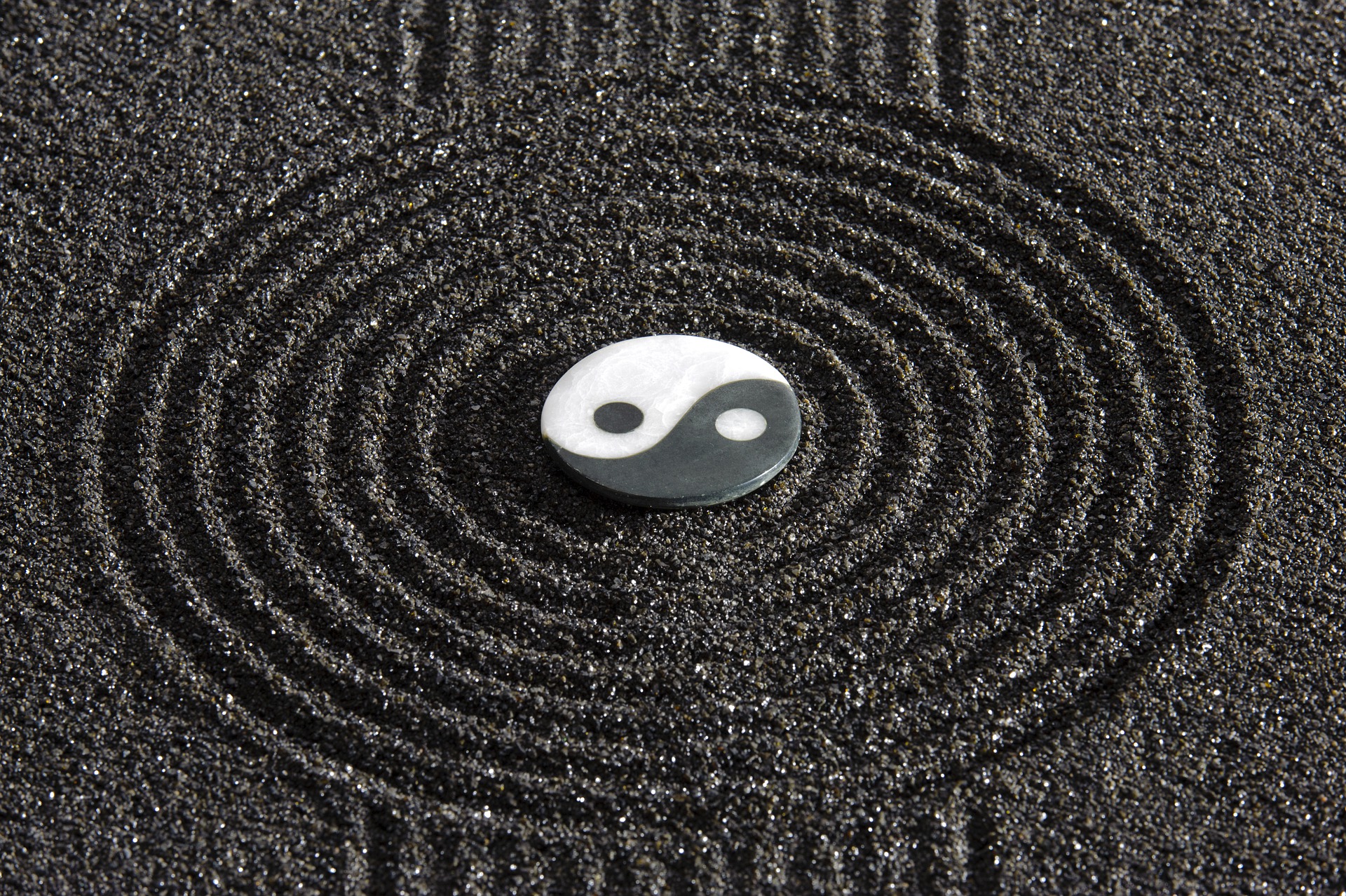 Yin and Yang Symbol centered in a black sand Zen design